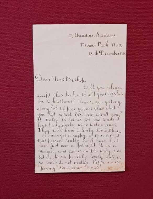 A cream letter lies flat on a red background