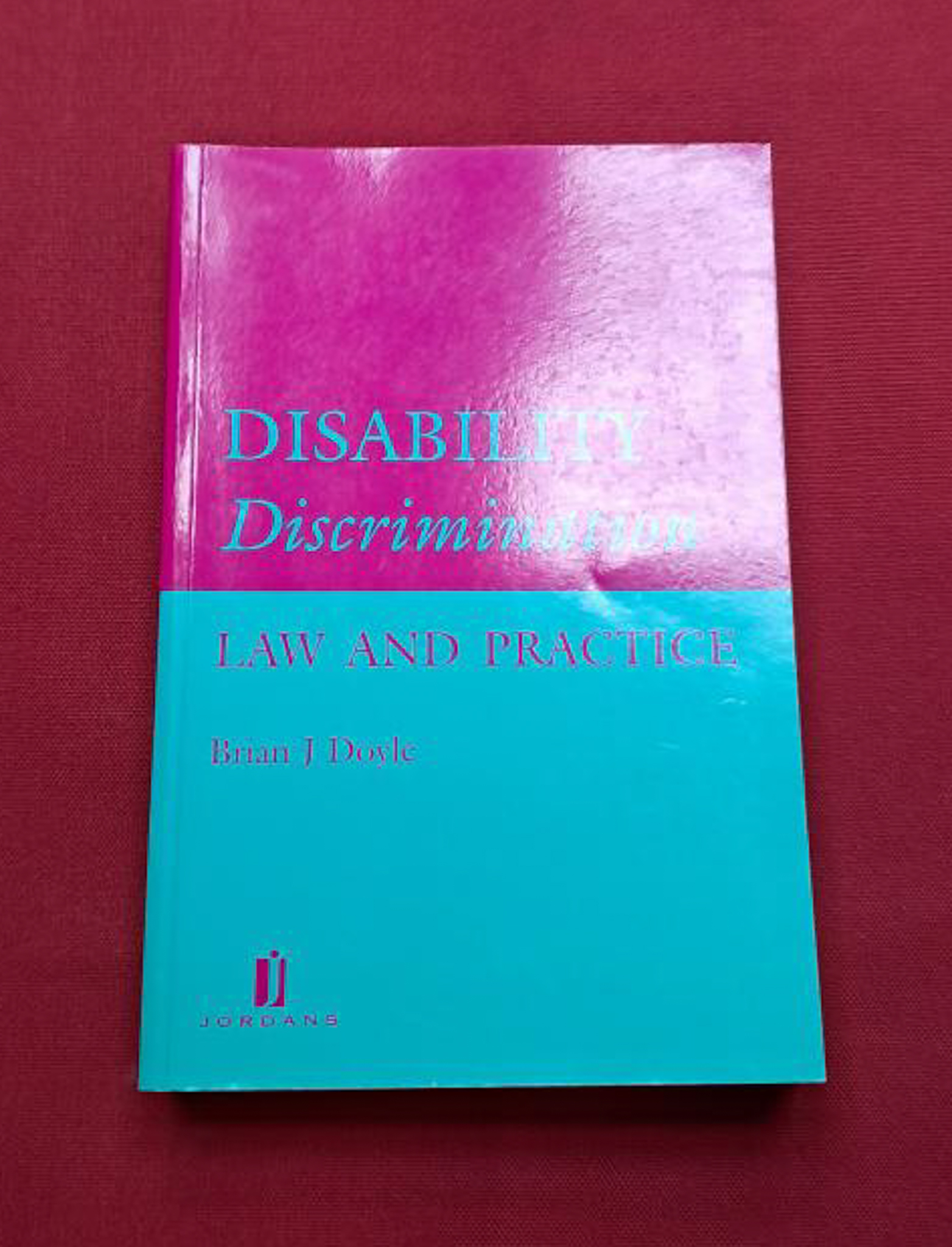 Disability Discrimination. Half bright pink and half bright green cover with opposite coloured text